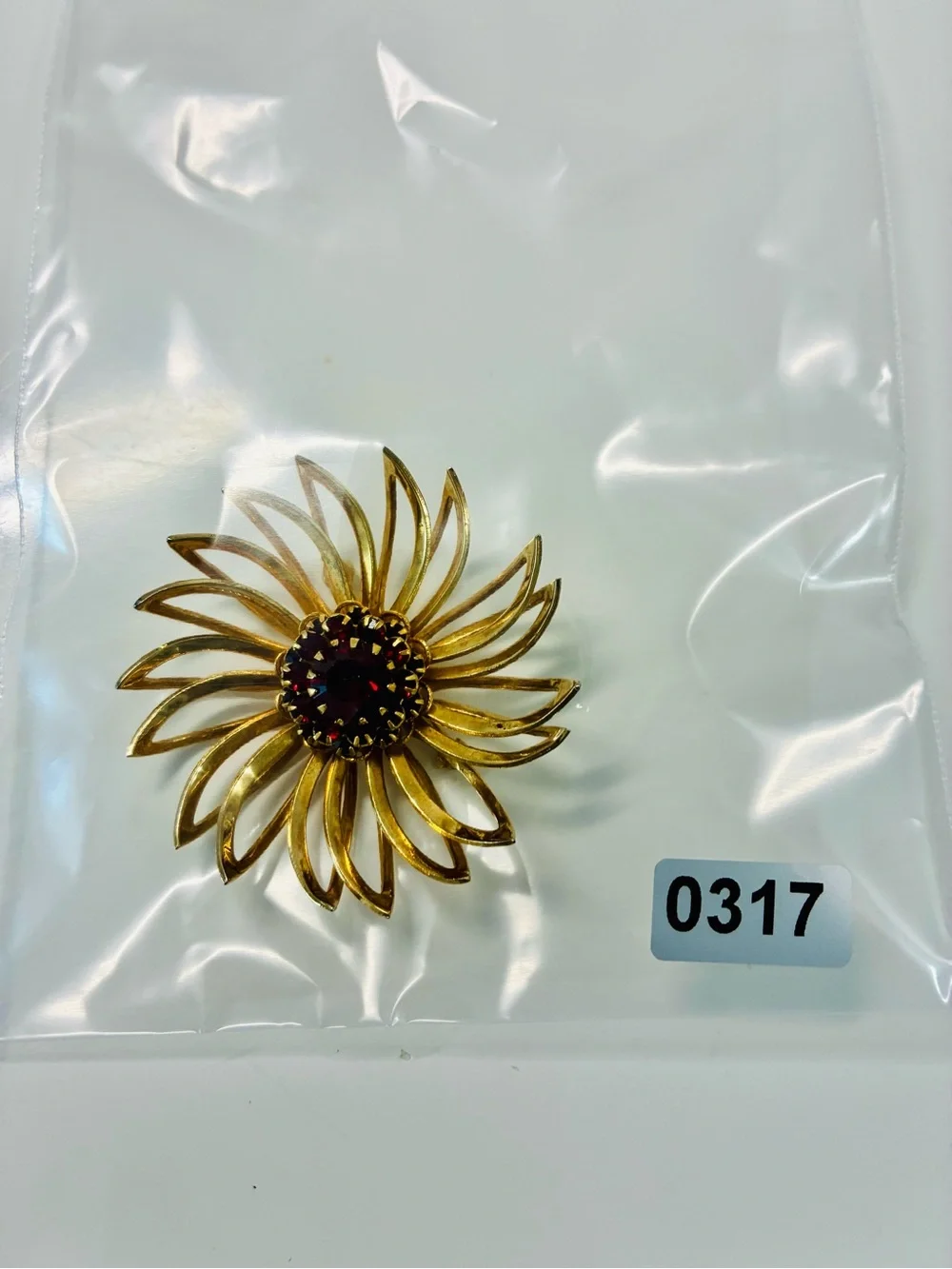 Sarah Coventry Gold-tone Sunburst Brooch with Deep Red Center